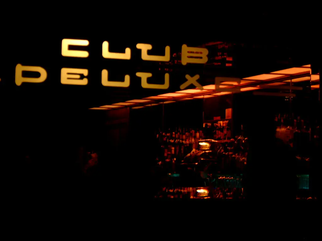 The illuminated Club DeLuxe neon sign at 1511 Haight Street - San Francisco