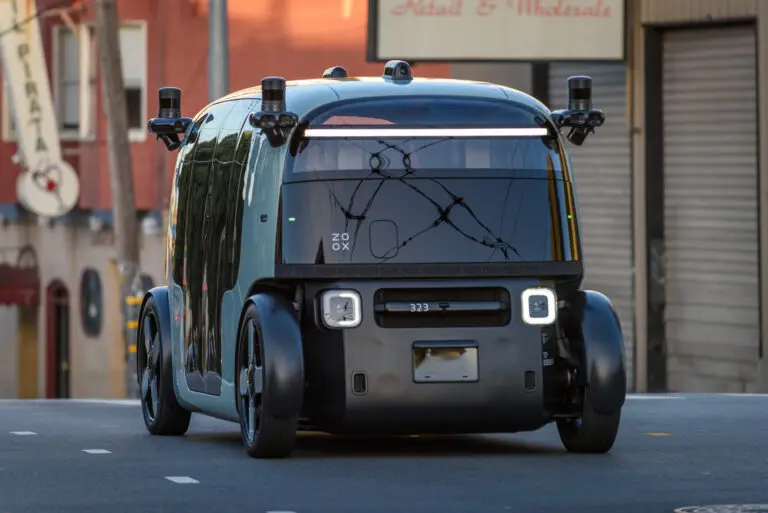 A purpose-built Zoox autonomous robotaxi, which has no steering wheel or pedals, on a San Francisco street - San Francisco