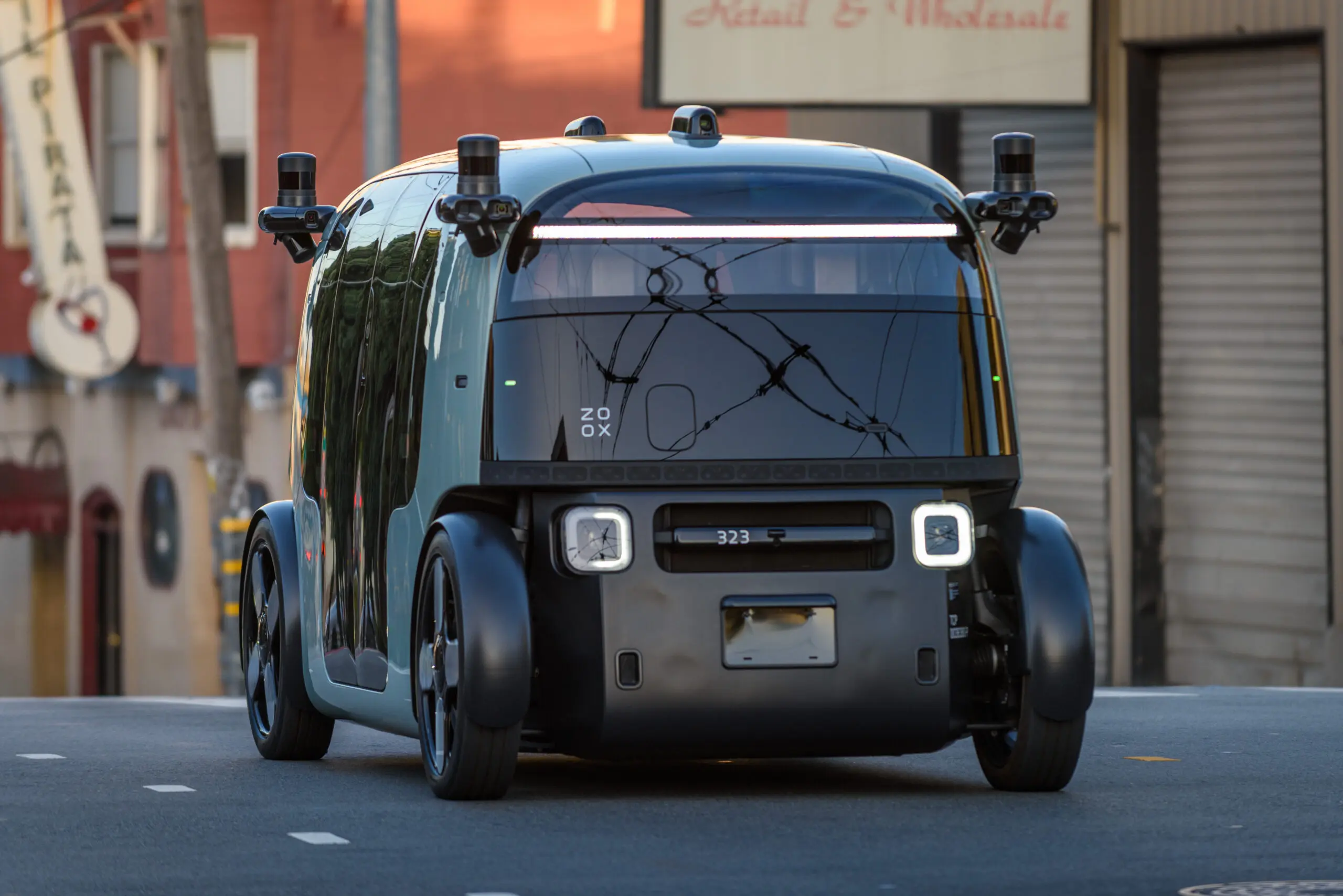 A purpose-built Zoox autonomous robotaxi, which has no steering wheel or pedals, on a San Francisco street - San Francisco