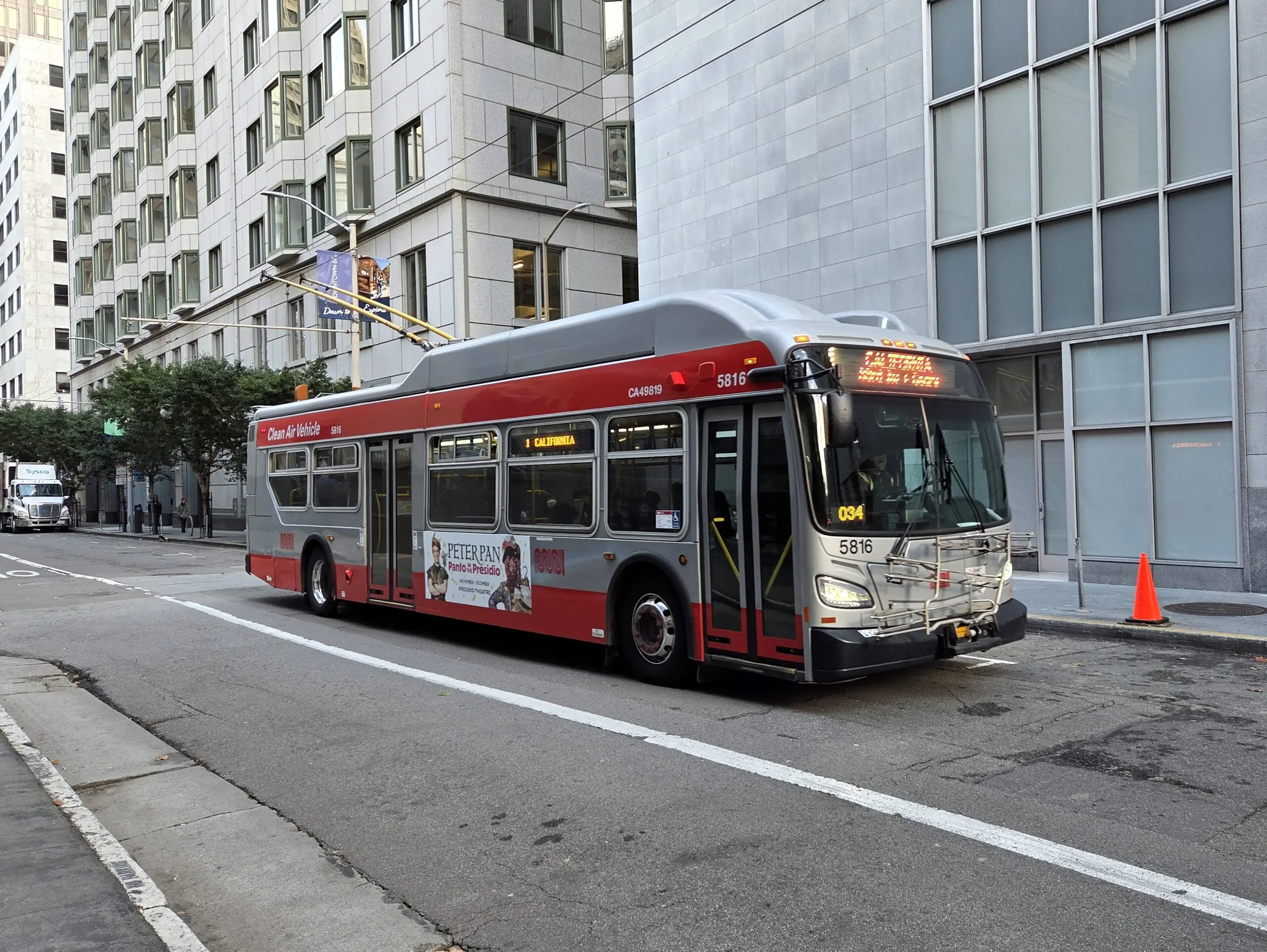 A Muni 1 California trolleybus on a downtown street - San Francisco
