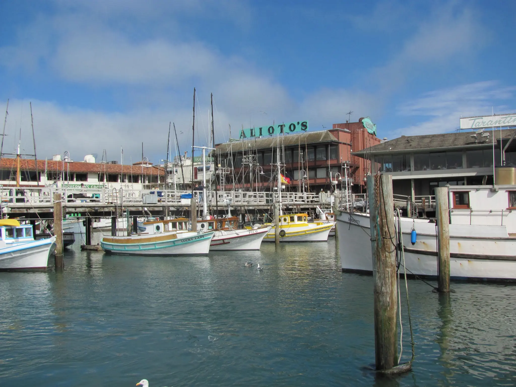 Fishing boats moored at Fisherman's Wharf in front of the Alioto's restaurant building, the site of the new Alioto's Plaza - San Francisco