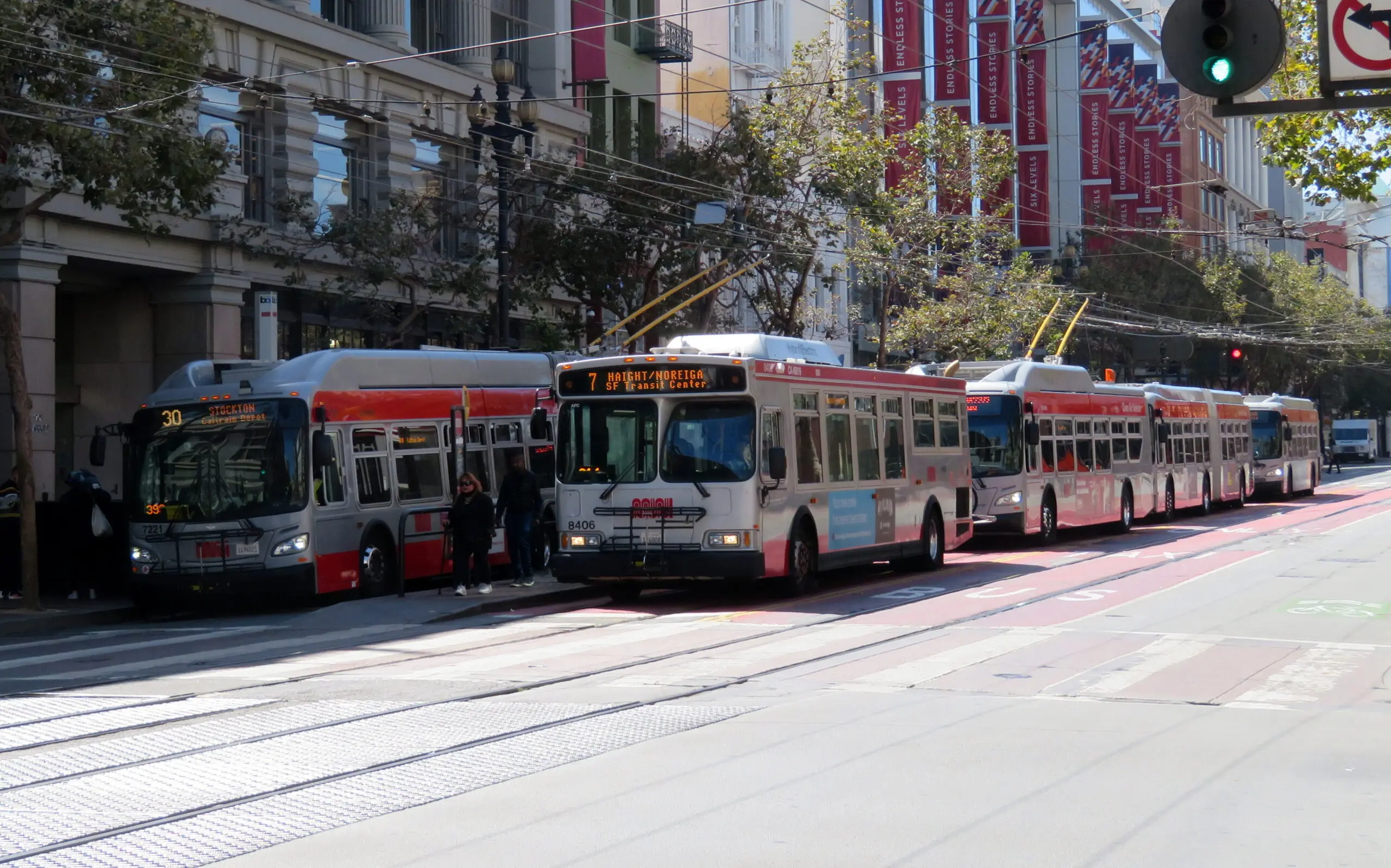 Muni buses lined up at Market and 5th Street with their route headsigns lit - San Francisco