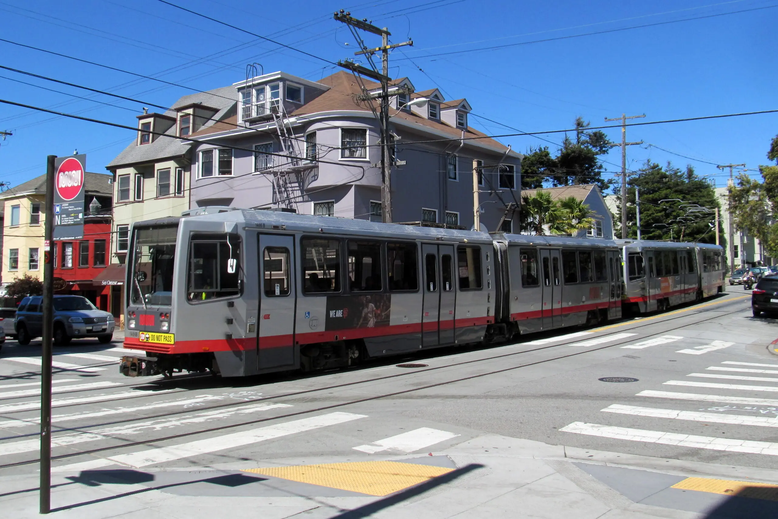 An outbound N Judah train crossing Cole Street in the Cole Valley commercial corridor - San Francisco