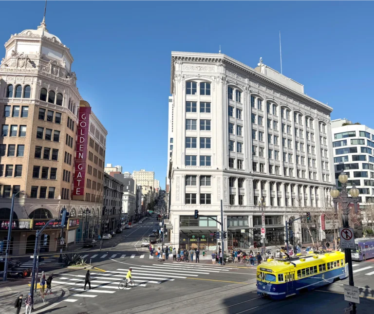 The Warfield Commons building at 988 Market Street with an F-line streetcar in front - San Francisco